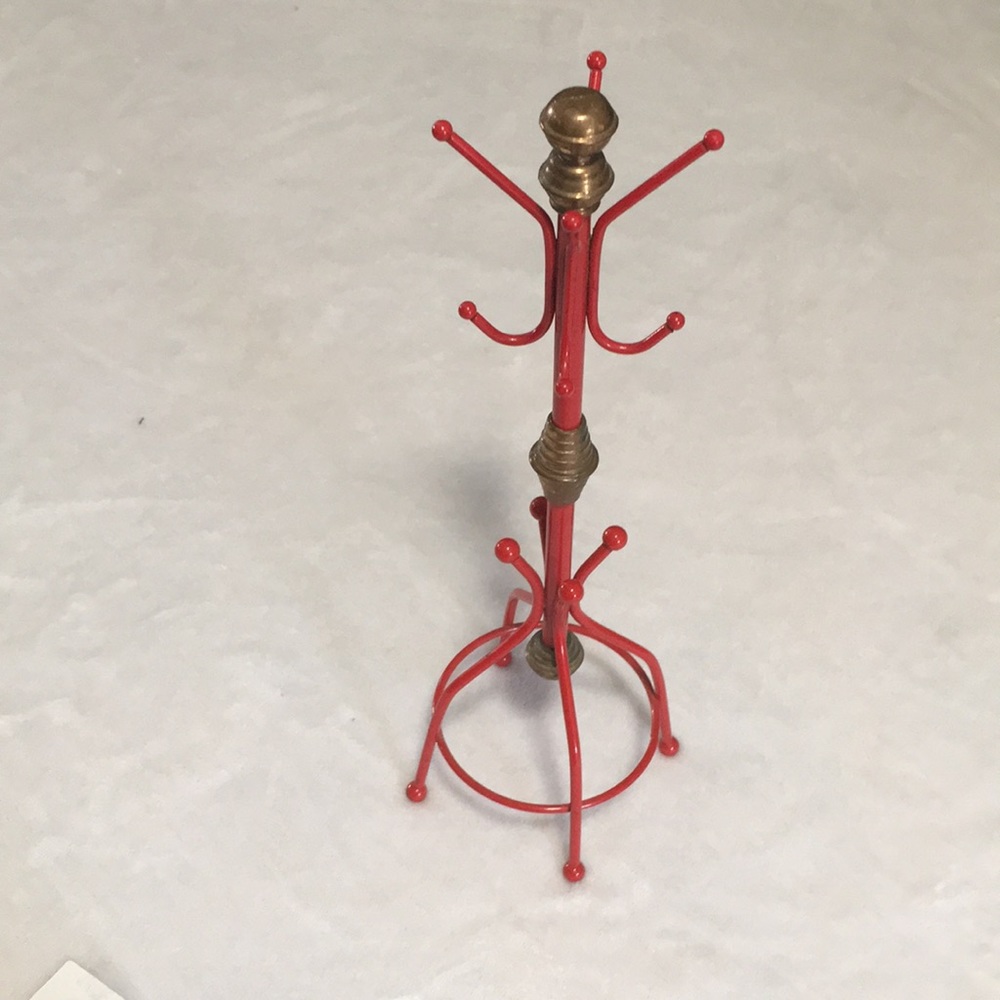 Red metal tower jewelry holder.